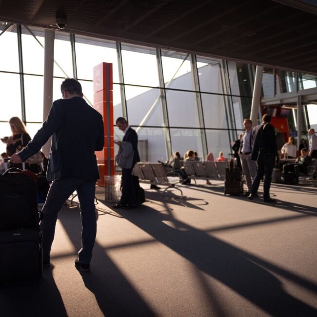 Busy travelers inside an airport terminal