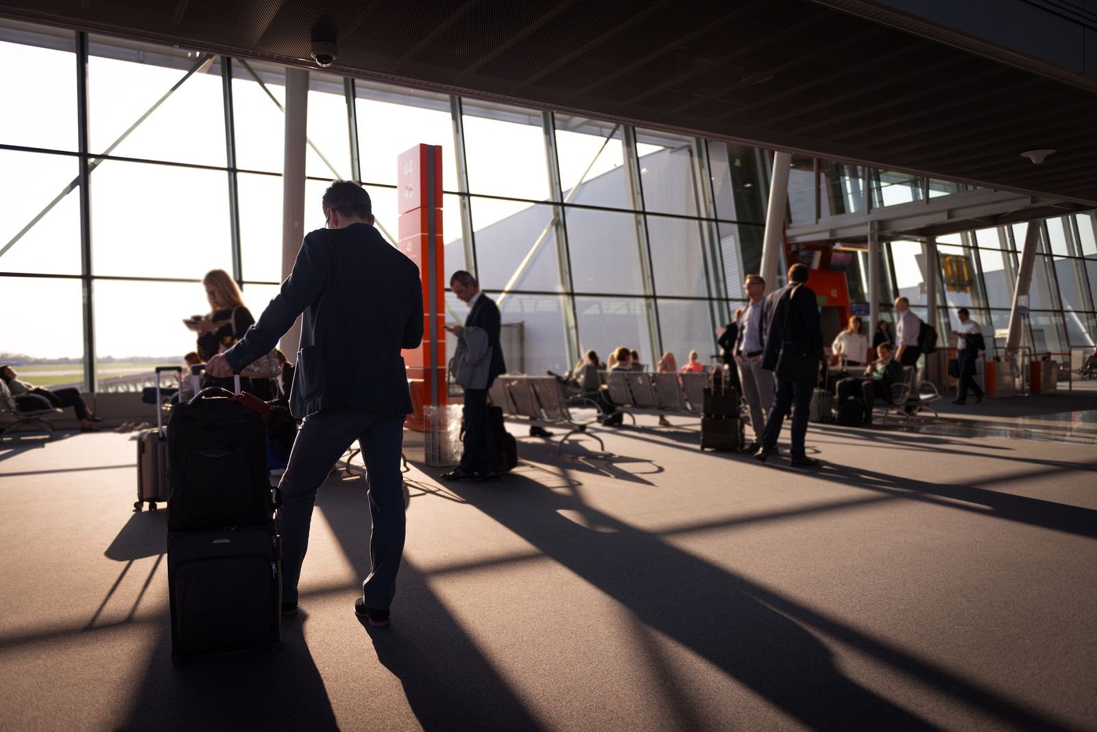 Busy travelers inside an airport terminal