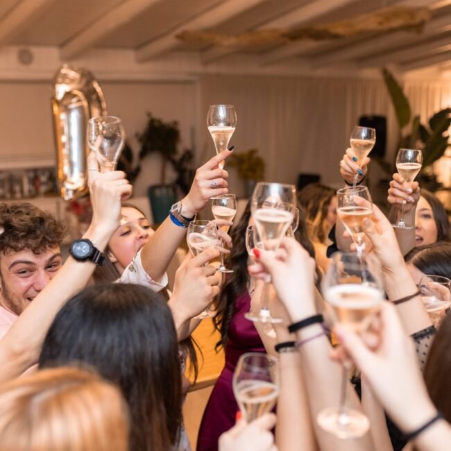Friends clinking champagne glasses at a restaurant