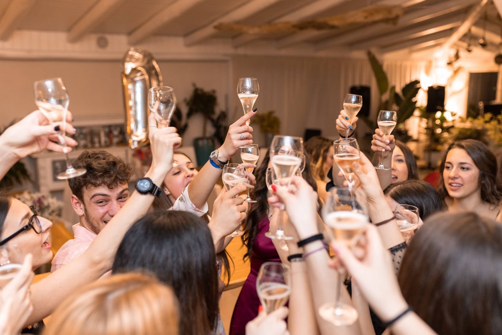 Friends clinking champagne glasses at a restaurant