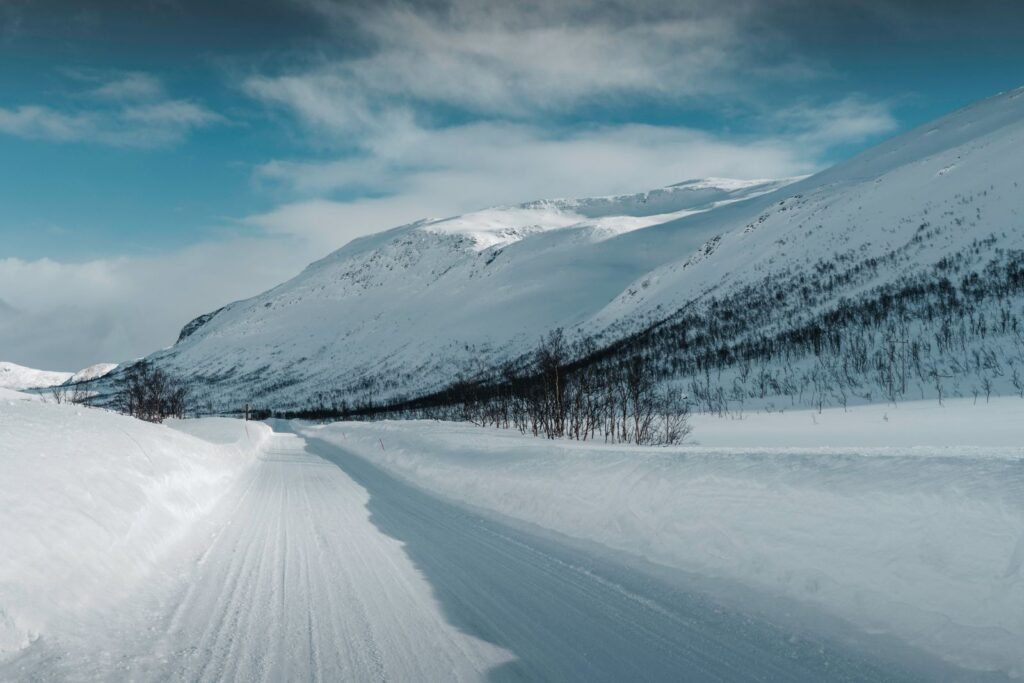 Snowy road winding through winter mountains