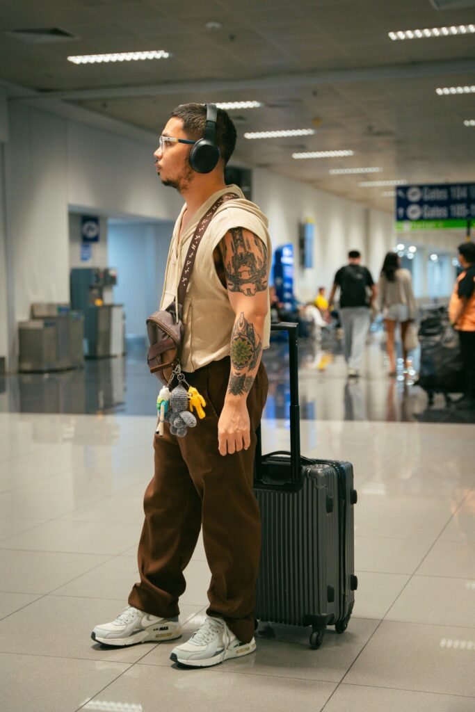 Traveler with luggage walking through an airport terminal